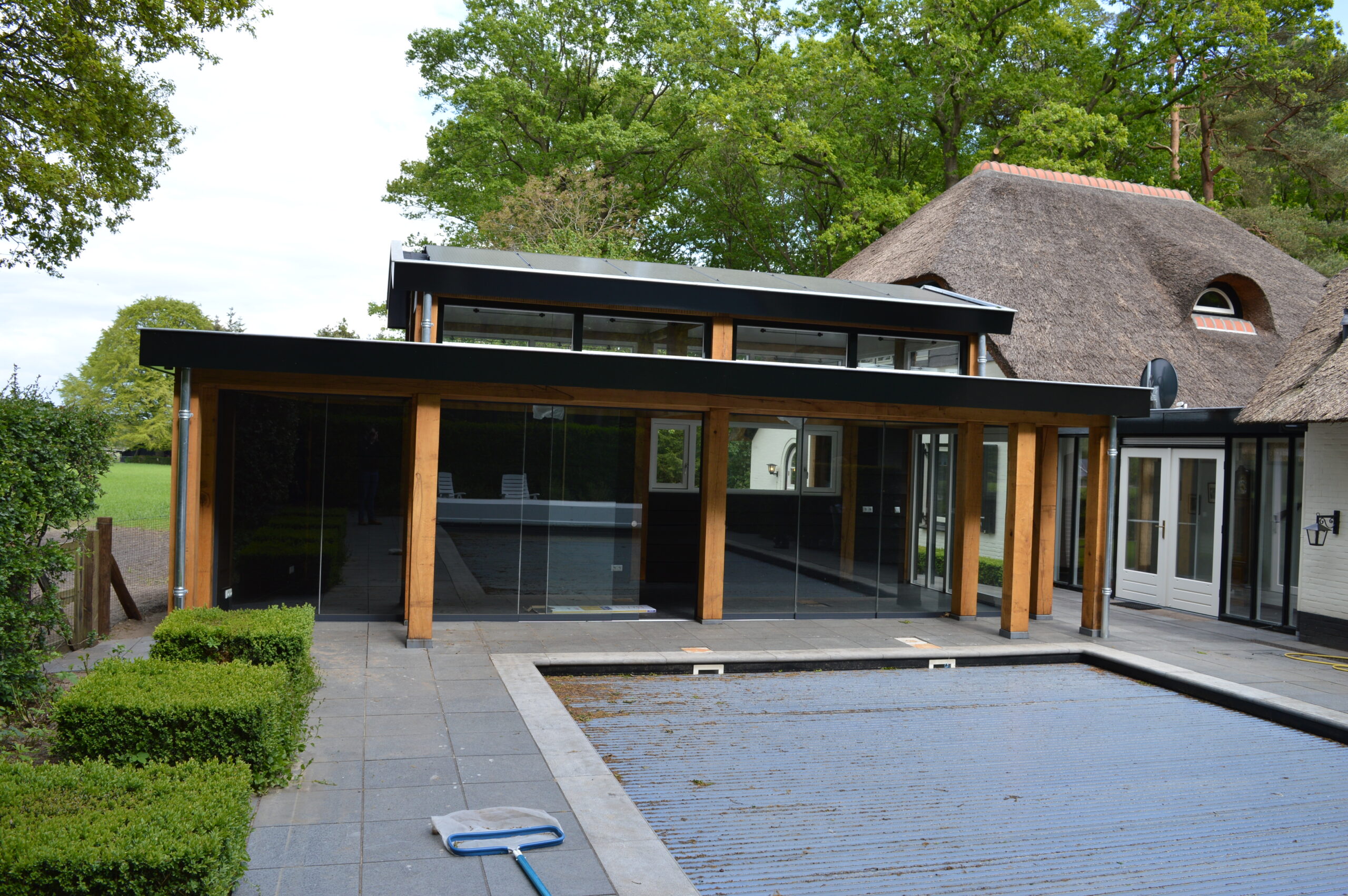 Robuuste houten tuinkamer bij een vrijstaande villa in Loenen.